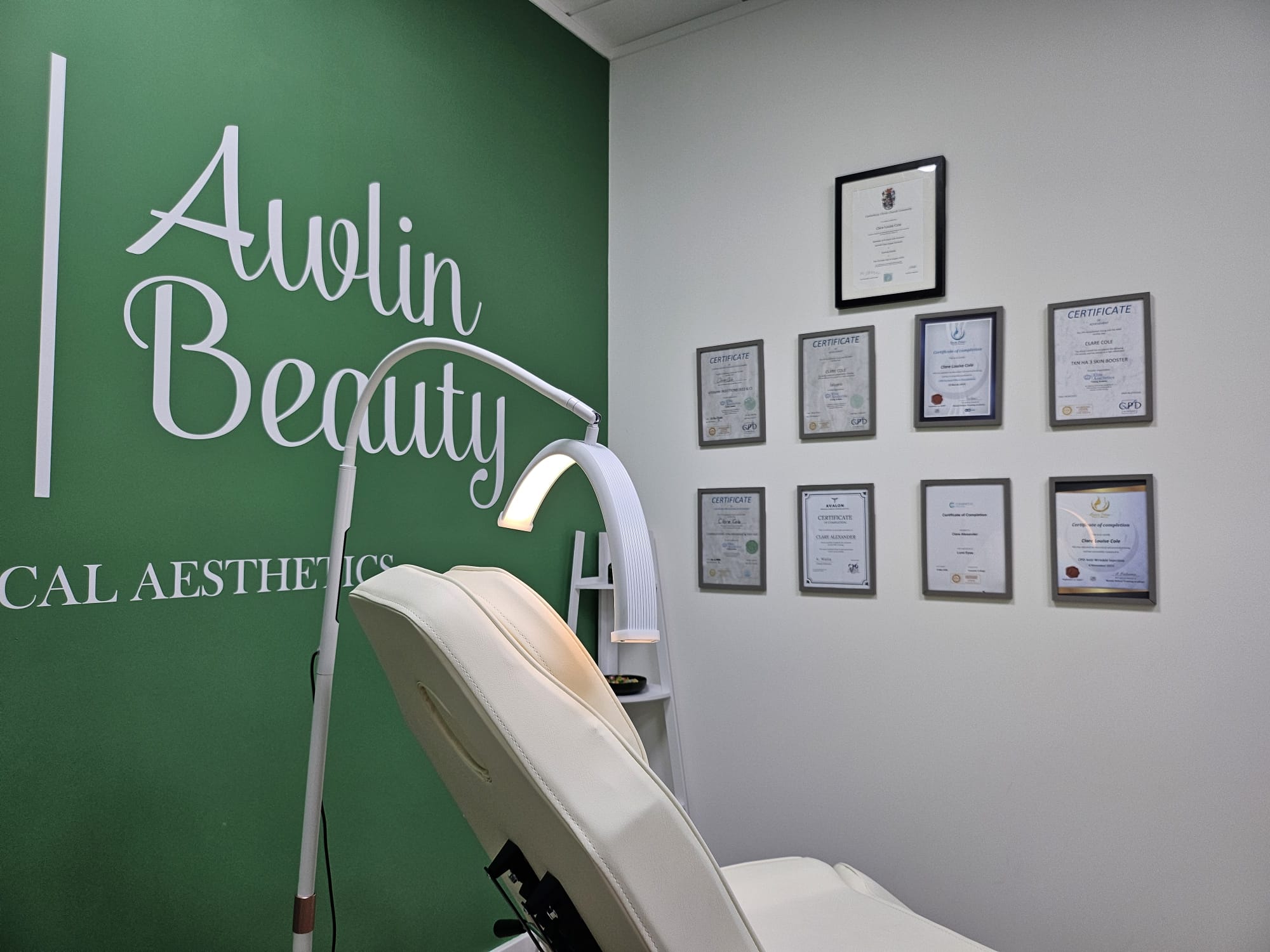 Treatment room at Awlin Beauty Medical Aesthetics in Maidstone, with treatment chair, examination light and Clare's framed aesthetics qualifications on the wall